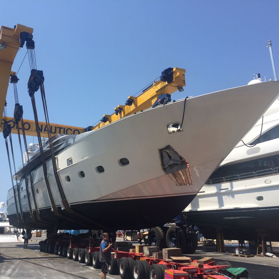 Luxury yachts docked at a marina by the yacht club.